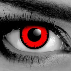 Close up of Gothika Angelic Red theatrical contact lenses with a jagged limbal ring, masking dark brown eyes.