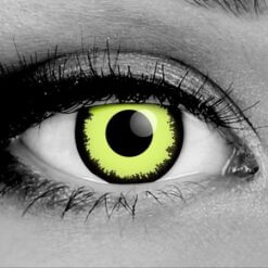 Close-up of Gothika Louis special effect contact lenses, inspired by Louis de Pointe du Lac from Interview with the Vampire. The lens features a vibrant neon yellowish-green iris with a distinctive pixelated black limbal ring, shown on a grayscale eye for high contrast. Perfect for realistic vampire cosplay and movie-quality character recreation.