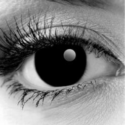 Close up of a Gothika Blackout theatrical contact lens, offering a demonic black eye look without a full scleral lens.